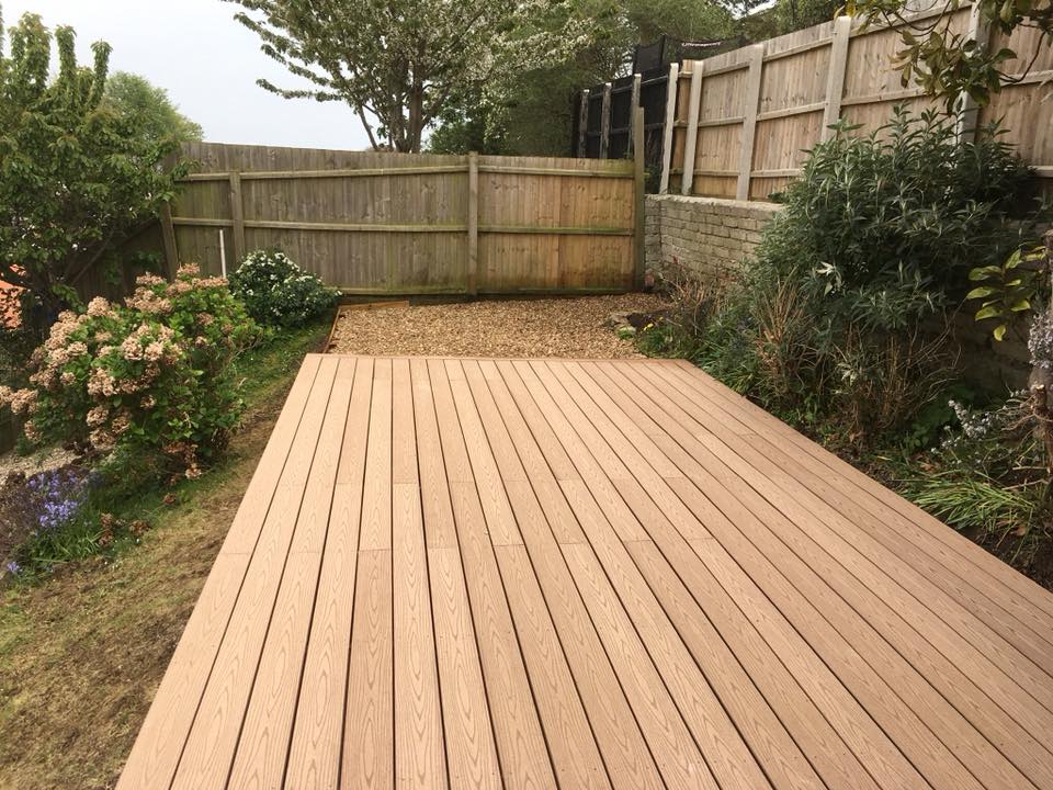 decking laid at the top of a slope in a back garden
